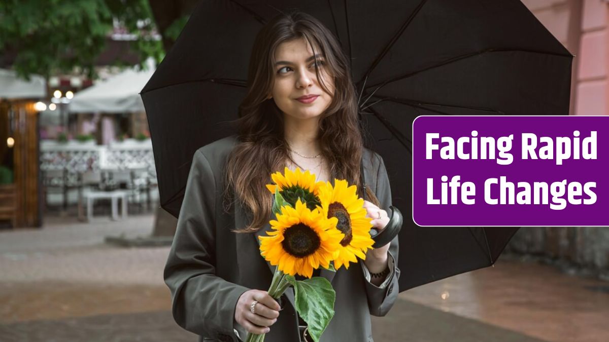 A young woman with a bouquet of sunflowers under an umbrella in rainy weather.