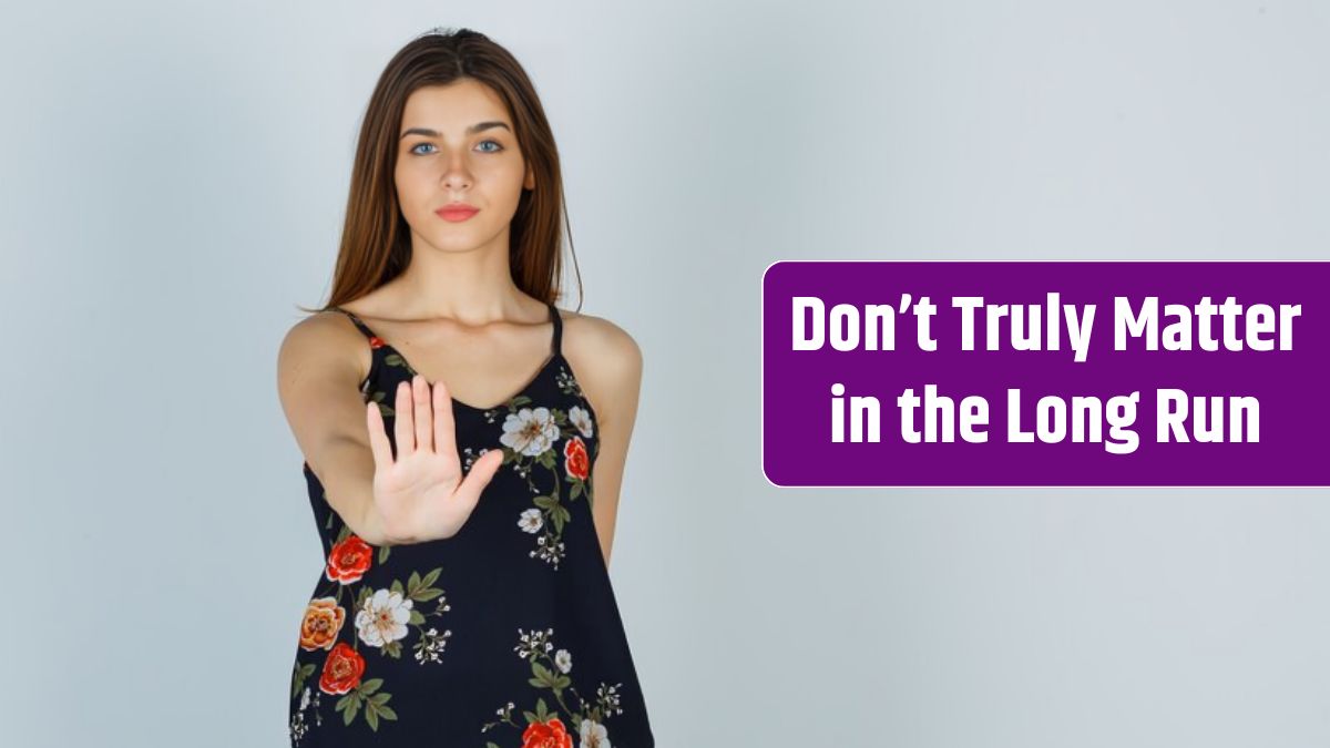 Young woman showing stop gesture in floral top and looking confident.