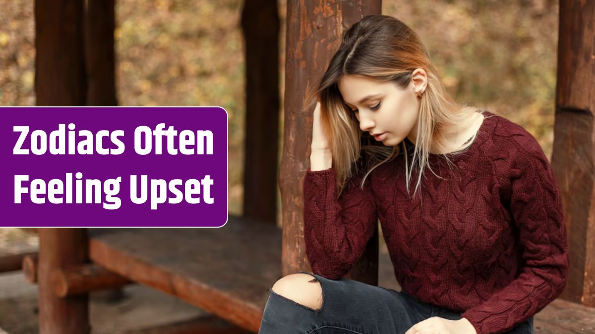 Beautiful young woman in a stylish knitted sweater sits on a wooden bench in nature.