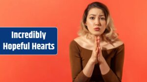 Portrait of sad guilty blonde woman in brown blouse took hands together and pray asking to forgive her and looking at the camera Indoor studio shoot isolated on red background.