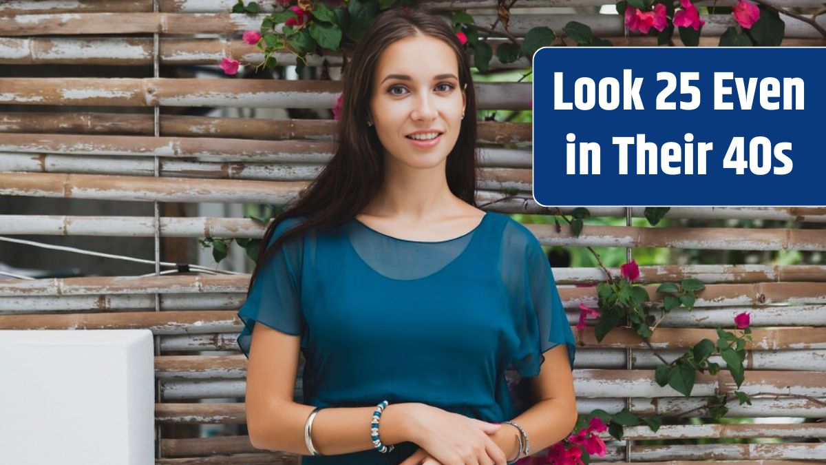 Young stylish beautiful woman in blue dress, summer fashion trend, vacation, garden, tropical hotel terrace, smiling.